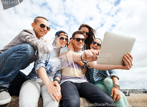 Image of group of teenagers looking at tablet pc