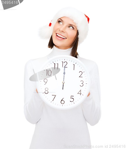 Image of woman in santa helper hat with clock showing 12