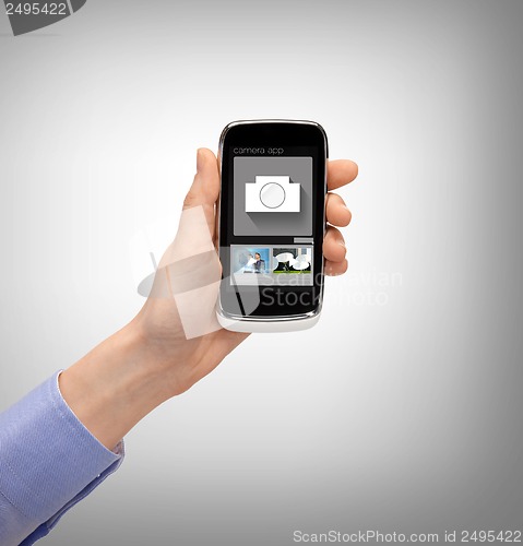 Image of hand with smartphone showing application