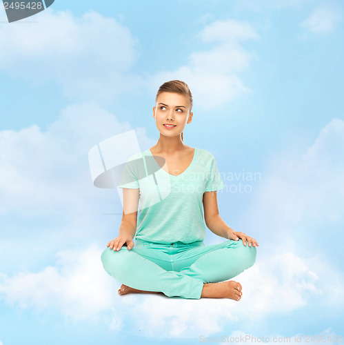 Image of girl sitting in lotus position and meditating