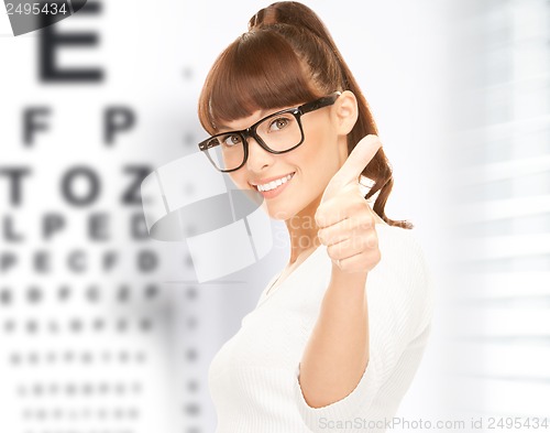 Image of woman in eyeglasses with eye chart