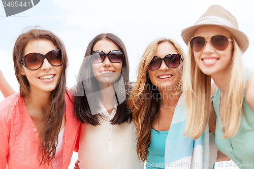 Image of girls in shades having fun on the beach