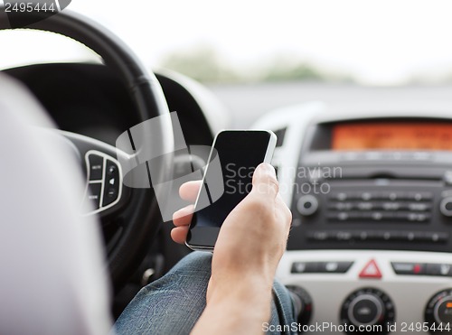 Image of man using phone while driving the car