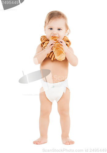 Image of cute todler eating long bread