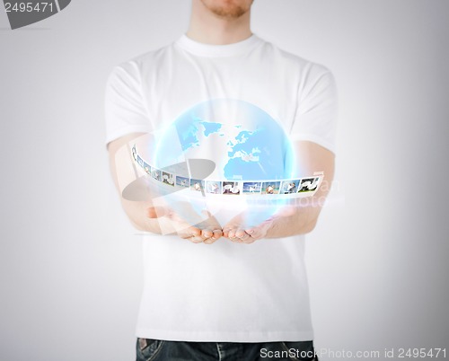 Image of man with virtual globe and news