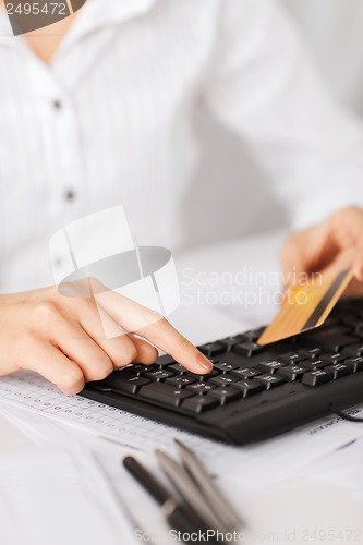 Image of businesswoman with laptop using credit card