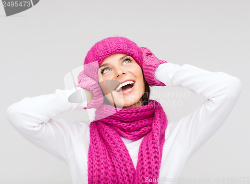 Image of surprised woman in hat, muffler and mittens