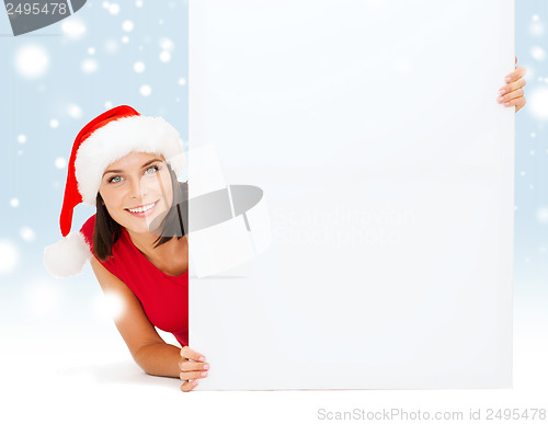 Image of woman in santa helper hat with blank white board