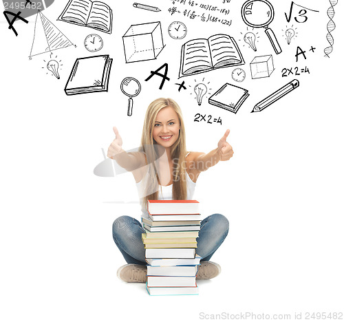 Image of student with stack of books