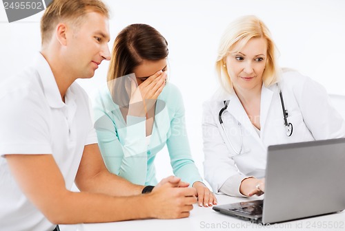 Image of doctor with patients in hospital