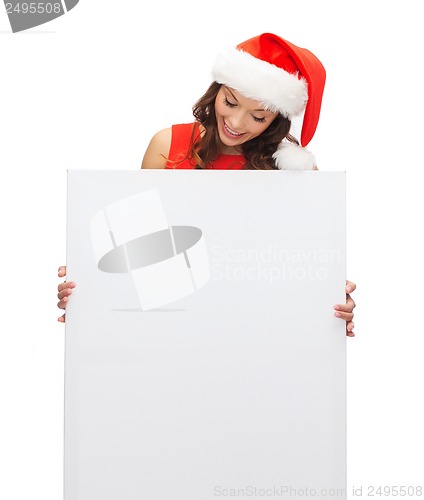 Image of woman in santa helper hat with blank white board