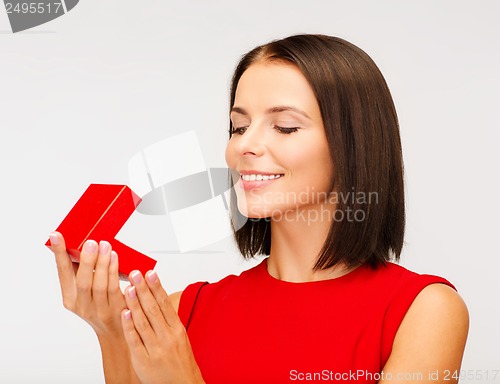 Image of surprised woman in red dress with gift box