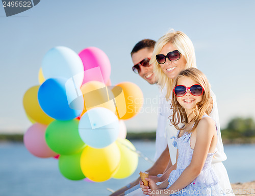 Image of family with colorful balloons