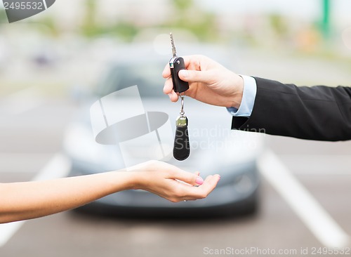 Image of customer and salesman with car key