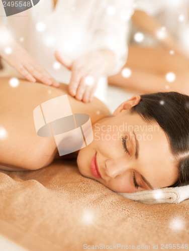 Image of woman in spa salon getting massage