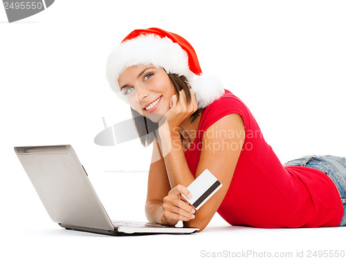 Image of woman in santa hat with laptop and credit card