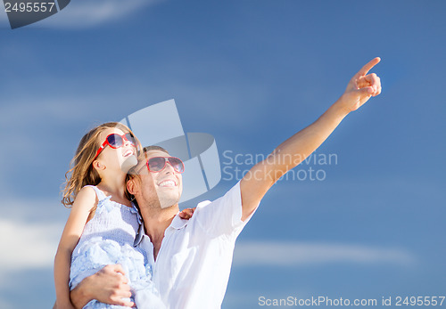 Image of happy father and child in sunglasses over blue sky