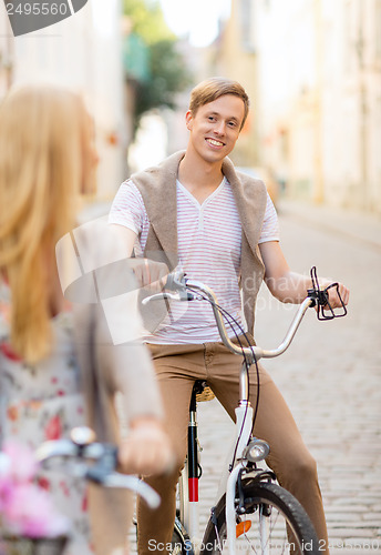 Image of couple with bicycles in the city