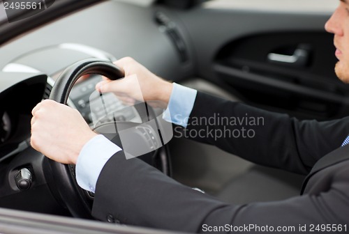 Image of businessman driving a car