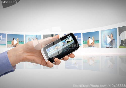 Image of woman with smartphone and virtual screens