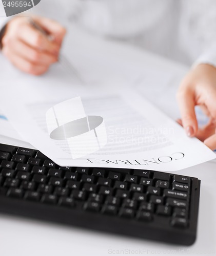 Image of woman hand signing contract paper