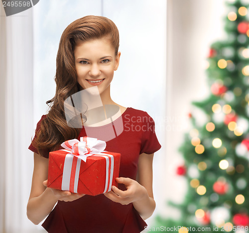 Image of smiling woman in red dress with gift box