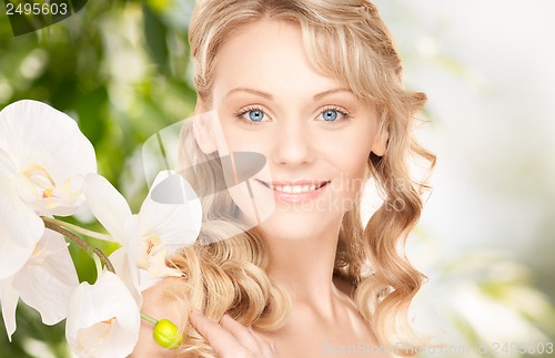 Image of beautiful woman with orchid flower