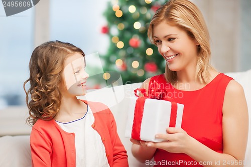 Image of happy mother and child girl with gift box