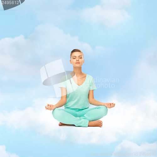 Image of girl sitting in lotus position and meditating