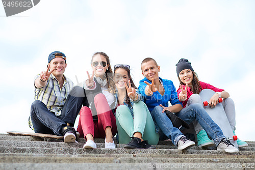 Image of group of teenagers showing finger five