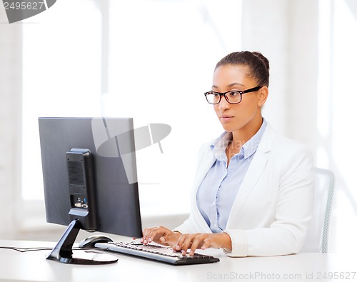Image of african businesswoman with computer in office