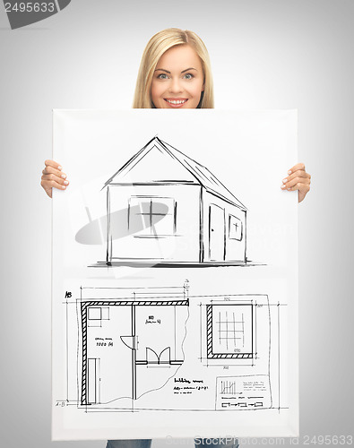 Image of woman holding picture with house