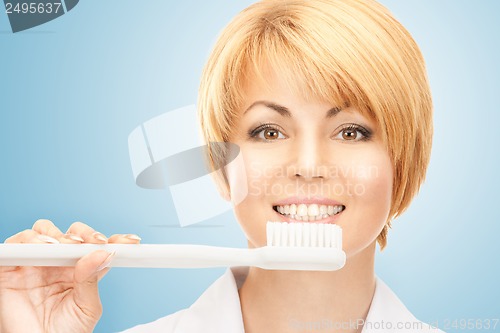 Image of doctor with toothbrush