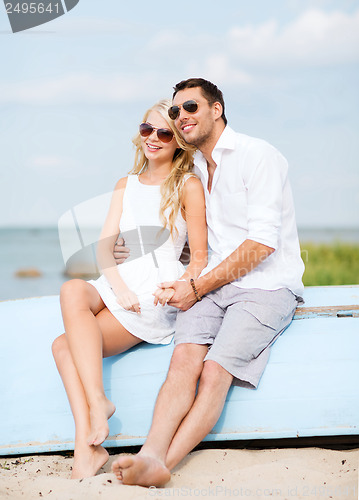 Image of couple in shades at sea side