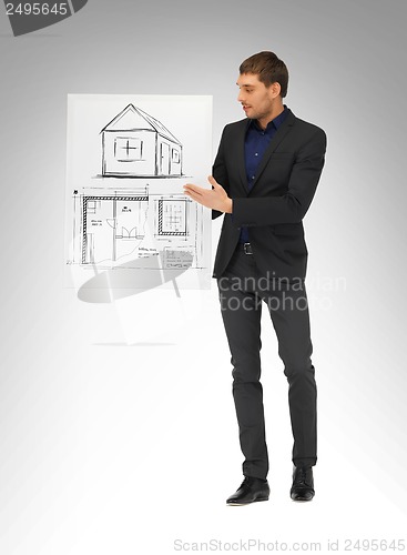 Image of man holding picture with house