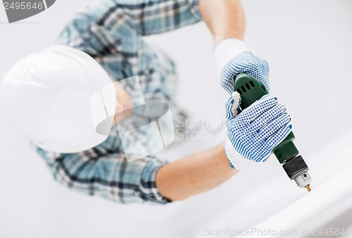 Image of man drilling the wall