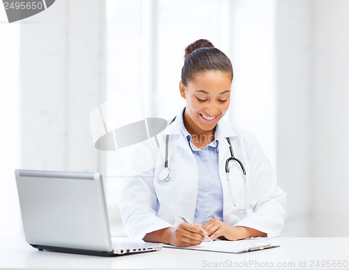 Image of female doctor with laptop pc