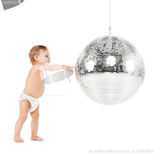 Image of toddler playing with disco ball