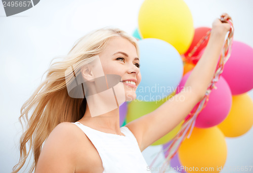 Image of woman with colorful balloons outside