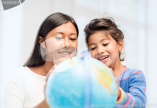 Image of mother and daughter with globe