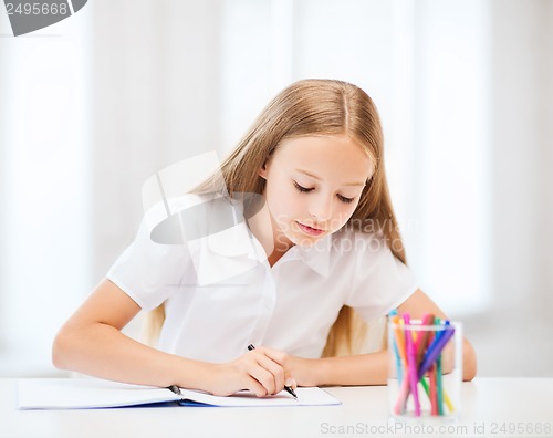 Image of little student girl drawing at school