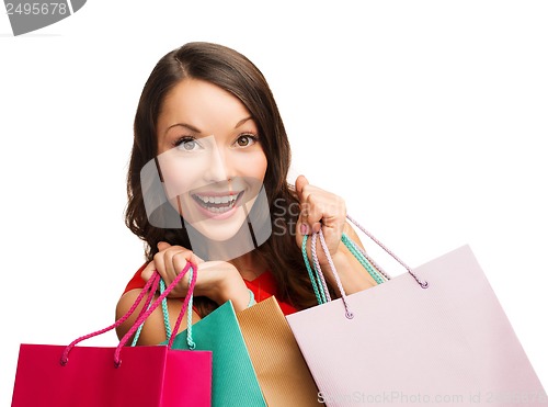 Image of woman in red dress with shopping bags