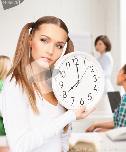 Image of student showing clock