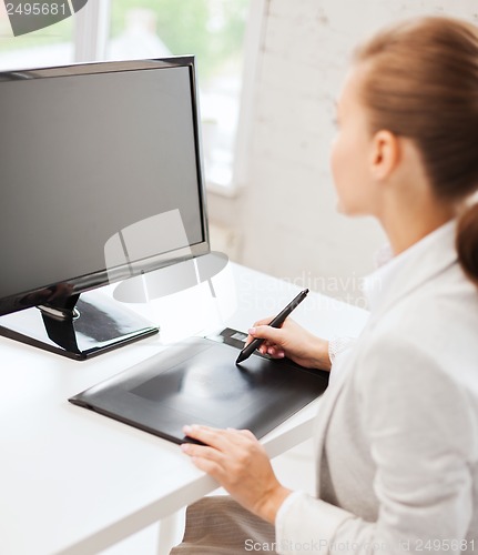 Image of businesswoman with drawing tablet in office