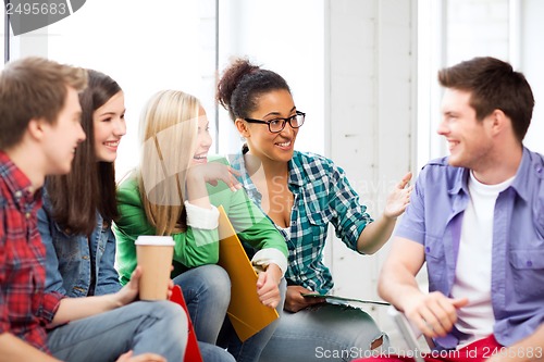 Image of students communicating and laughing at school