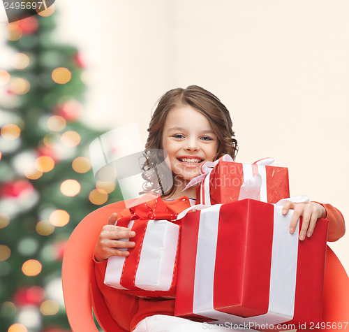 Image of happy child girl with gift boxes