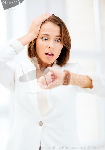 Image of stressed businesswoman looking at clock