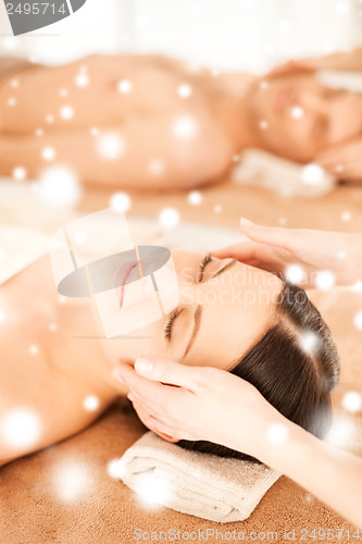 Image of couple in spa salon getting face treatment