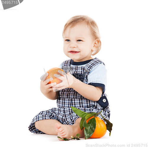 Image of cute toddler eating orange