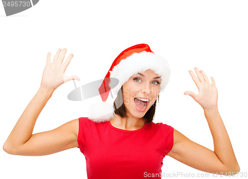 Image of surprised woman in santa helper hat